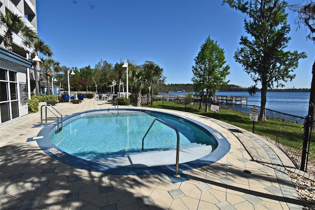 13427 Blue Heron Beach Dr Unit 1802, Orlando, FL 32821 - community pool with a patio, a water view, and fence