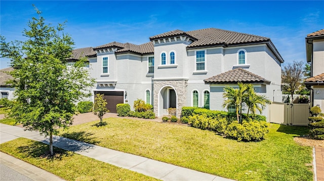 8384 Ludington Cir, Orlando, FL 32836 - mediterranean / spanish home featuring a front lawn, a tile roof, stucco siding, and a garage