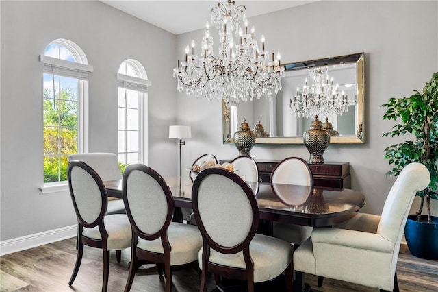 8384 Ludington Cir, Orlando, FL 32836 - dining area featuring baseboards, wood finished floors, and a notable chandelier