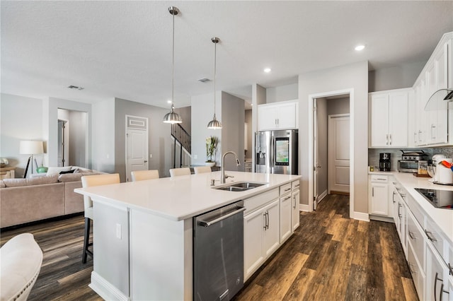 8384 Ludington Cir, Orlando, FL 32836 - kitchen with an island with sink, a sink, dark wood finished floors, open floor plan, and stainless steel appliances