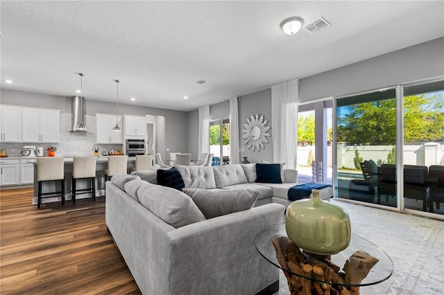 8384 Ludington Cir, Orlando, FL 32836 - living room with a textured ceiling, dark wood-style floors, and visible vents