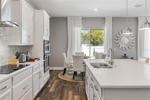 8384 Ludington Cir, Orlando, FL 32836 - kitchen featuring light countertops, dark wood finished floors, decorative backsplash, a center island with sink, and wall chimney range hood