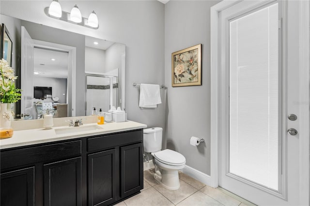 8384 Ludington Cir, Orlando, FL 32836 - bathroom featuring a shower stall, baseboards, toilet, tile patterned floors, and vanity