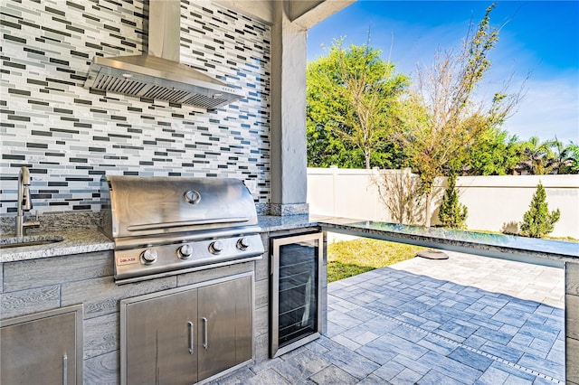 8384 Ludington Cir, Orlando, FL 32836 - view of patio / terrace featuring fence, wine cooler, a grill, a sink, and an outdoor kitchen