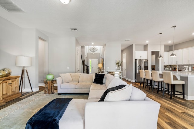 8384 Ludington Cir, Orlando, FL 32836 - living room with wood finished floors, a textured ceiling, baseboards, and visible vents