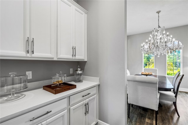 8384 Ludington Cir, Orlando, FL 32836 - bar with a chandelier, baseboards, pendant lighting, and wood finished floors