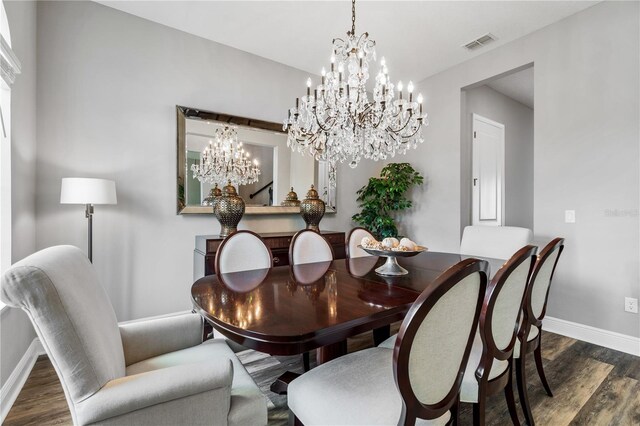 8384 Ludington Cir, Orlando, FL 32836 - dining area with baseboards, visible vents, a notable chandelier, and wood finished floors