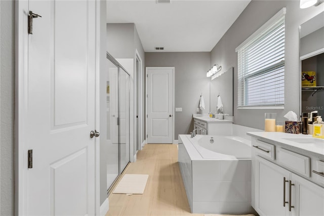 8384 Ludington Cir, Orlando, FL 32836 - bathroom with a bath, a shower stall, two vanities, and visible vents