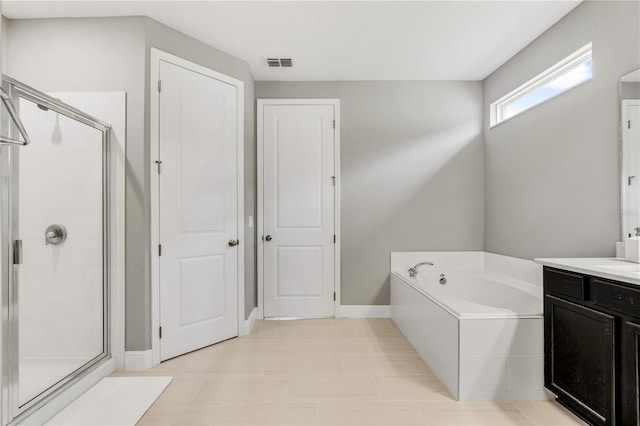 8384 Ludington Cir, Orlando, FL 32836 - bathroom with vanity, baseboards, a shower stall, visible vents, and a bath