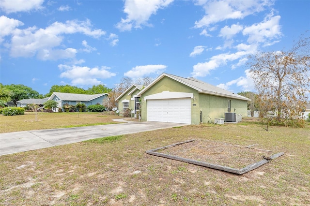 view of property exterior with driveway, cooling unit, stucco siding, a garage, and a yard