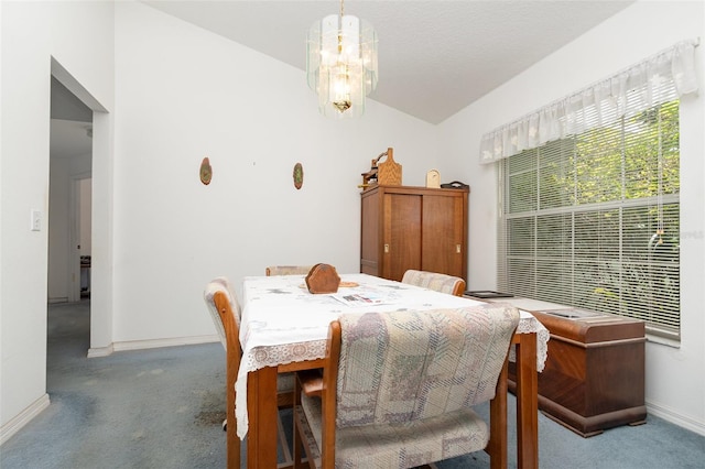 dining room with baseboards, lofted ceiling, carpet flooring, and a chandelier