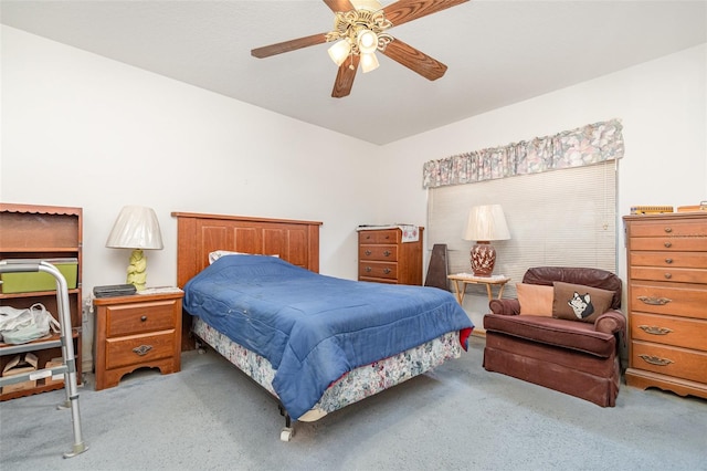 bedroom with a ceiling fan and light colored carpet
