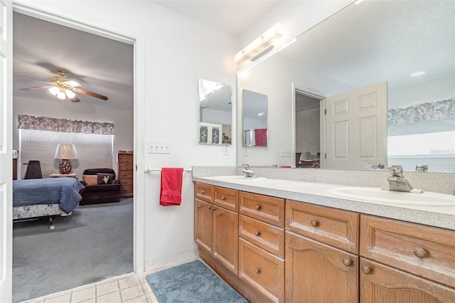 bathroom with a ceiling fan, a sink, connected bathroom, and double vanity