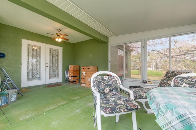 sunroom featuring french doors, beam ceiling, and ceiling fan