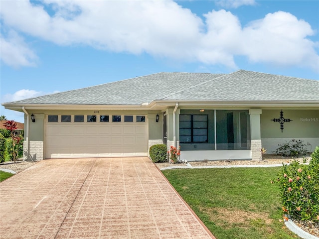 single story home featuring concrete driveway, stucco siding, and a front lawn