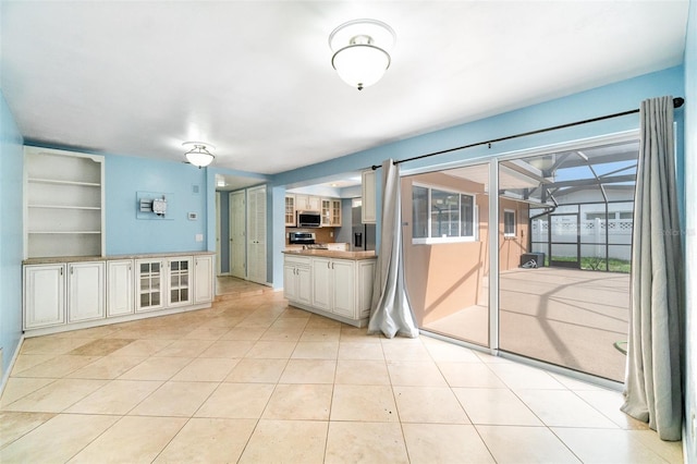 690 S Lakemont Ave, Winter Park, FL 32792 - unfurnished living room featuring light tile patterned flooring and built in shelves