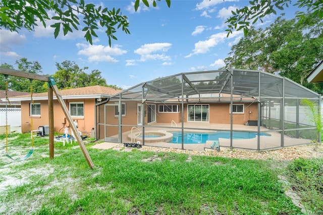 690 S Lakemont Ave, Winter Park, FL 32792 - rear view of house with stucco siding, an outdoor pool, an in-ground hot tub, and a patio area