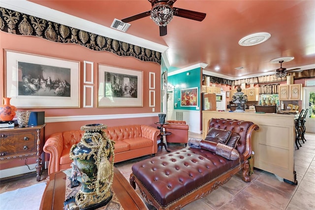 living area with a ceiling fan and visible vents