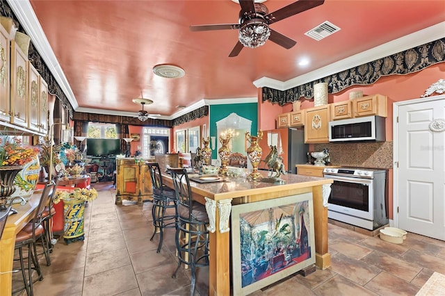 kitchen featuring crown molding, stainless steel appliances, light brown cabinets, visible vents, and ceiling fan