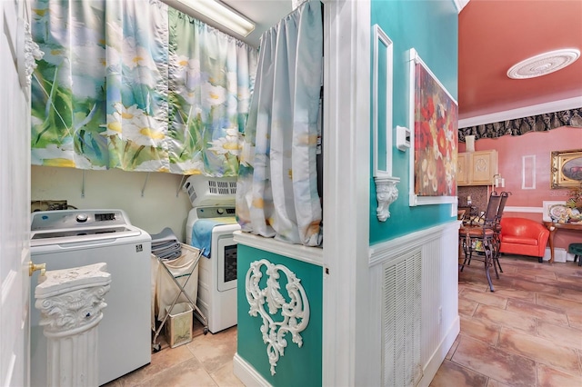 clothes washing area featuring washing machine and dryer and laundry area