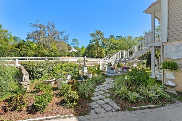 view of yard featuring stairs and fence