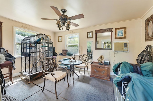 dining room featuring a wall mounted AC, baseboards, and ceiling fan