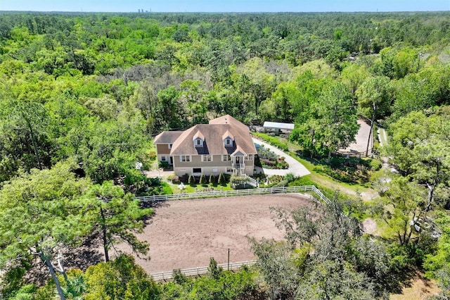 birds eye view of property with a view of trees