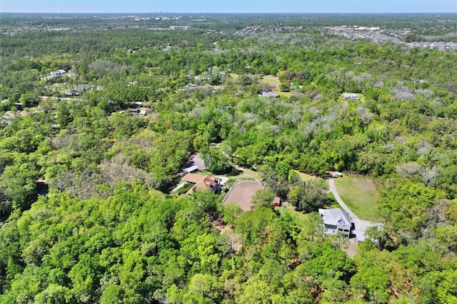 birds eye view of property featuring a view of trees