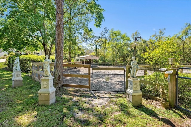 view of gate featuring fence