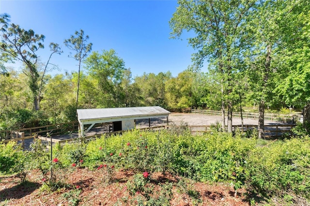 view of home's community featuring an outbuilding and fence