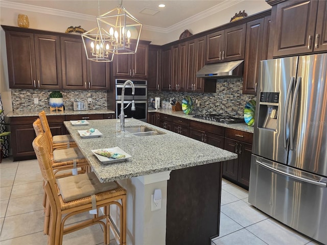 15149 Canoe Pl, Winter Garden, FL 34787 - kitchen with light tile patterned floors, appliances with stainless steel finishes, under cabinet range hood, and a chandelier
