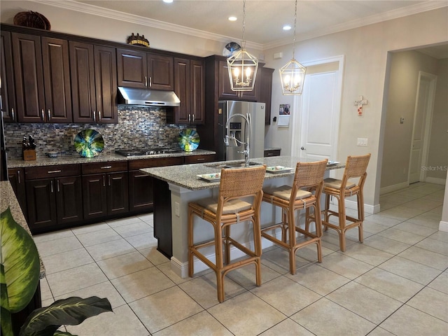 15149 Canoe Pl, Winter Garden, FL 34787 - kitchen featuring backsplash, light tile patterned flooring, appliances with stainless steel finishes, and under cabinet range hood