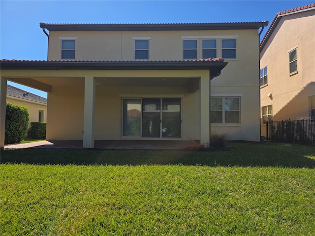 15149 Canoe Pl, Winter Garden, FL 34787 - back of house featuring fence, stucco siding, a tiled roof, and a yard