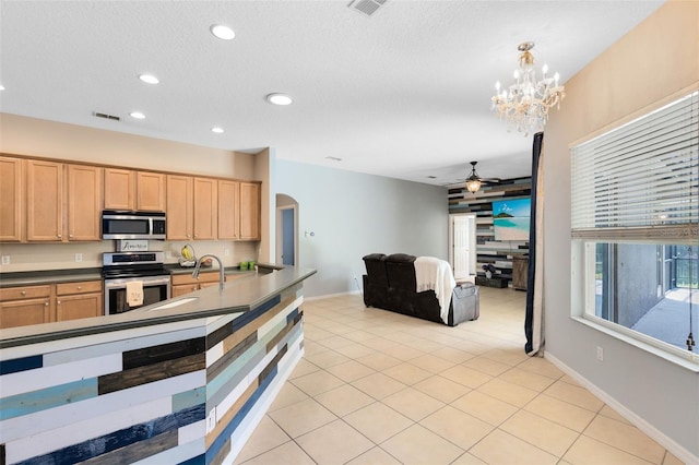 640 Brookfield Pl, Apopka, FL 32712 - kitchen with a sink, light brown cabinetry, stainless steel appliances, ceiling fan with notable chandelier, and arched walkways