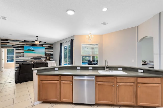 640 Brookfield Pl, Apopka, FL 32712 - kitchen featuring a sink, an accent wall, stainless steel dishwasher, open floor plan, and arched walkways