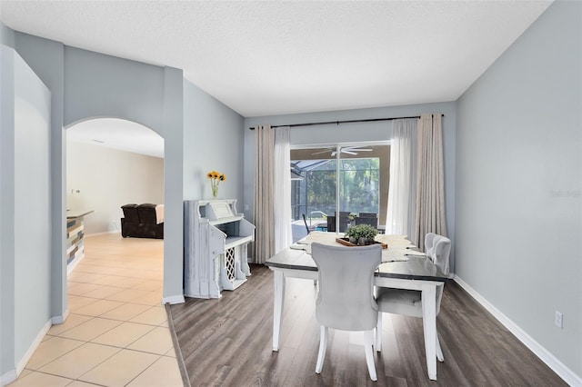 640 Brookfield Pl, Apopka, FL 32712 - dining space with wood finished floors, arched walkways, baseboards, and a textured ceiling