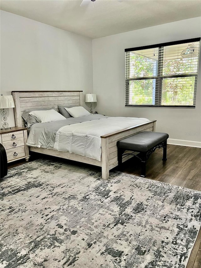 bedroom featuring baseboards and wood finished floors