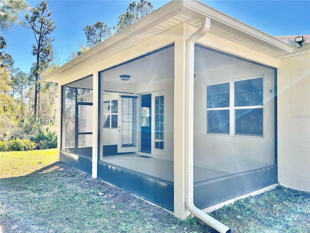 view of side of property with a sunroom