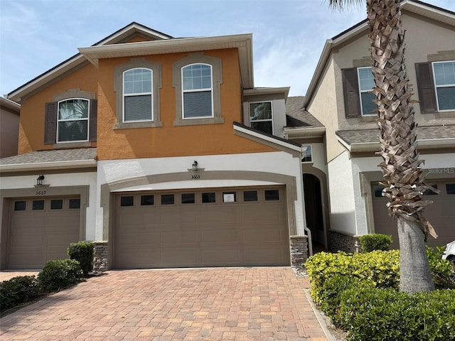 3665 Brighton Park Cir, Orlando, FL 32812 - view of front of house featuring decorative driveway, stucco siding, and an attached garage