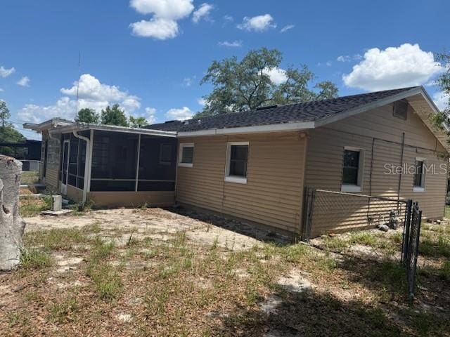 2108 Wolf Rd, Orlando, FL 32808 - back of house with a sunroom and fence