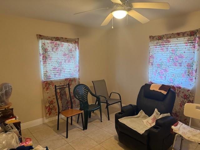 2108 Wolf Rd, Orlando, FL 32808 - living area with light tile patterned flooring, a ceiling fan, and baseboards