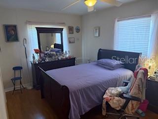 2108 Wolf Rd, Orlando, FL 32808 - bedroom with multiple windows, baseboards, ceiling fan, and wood finished floors