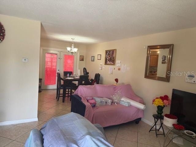 2108 Wolf Rd, Orlando, FL 32808 - living area featuring a chandelier, light tile patterned floors, and baseboards