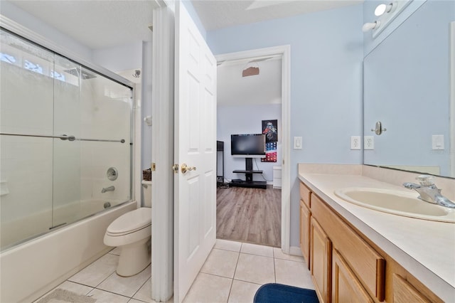 654 Chadbury Way, Kissimmee, FL 34744 - full bath with toilet, tile patterned flooring, vanity, and bath / shower combo with glass door