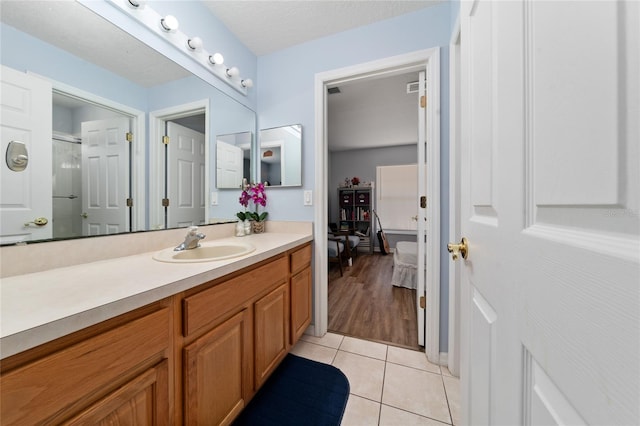 654 Chadbury Way, Kissimmee, FL 34744 - bathroom with an enclosed shower, tile patterned floors, and vanity