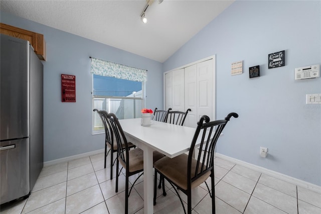 654 Chadbury Way, Kissimmee, FL 34744 - dining room featuring light tile patterned flooring, baseboards, vaulted ceiling, and track lighting