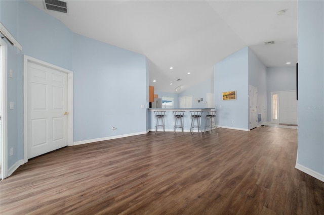 654 Chadbury Way, Kissimmee, FL 34744 - unfurnished living room featuring wood finished floors, high vaulted ceiling, and visible vents