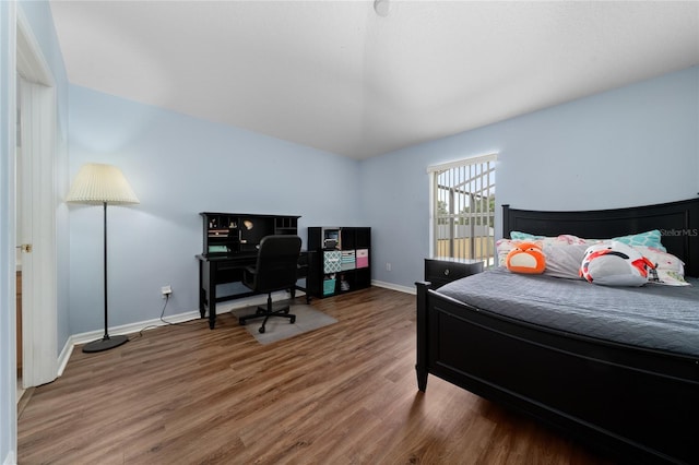 654 Chadbury Way, Kissimmee, FL 34744 - bedroom with baseboards, lofted ceiling, and wood finished floors