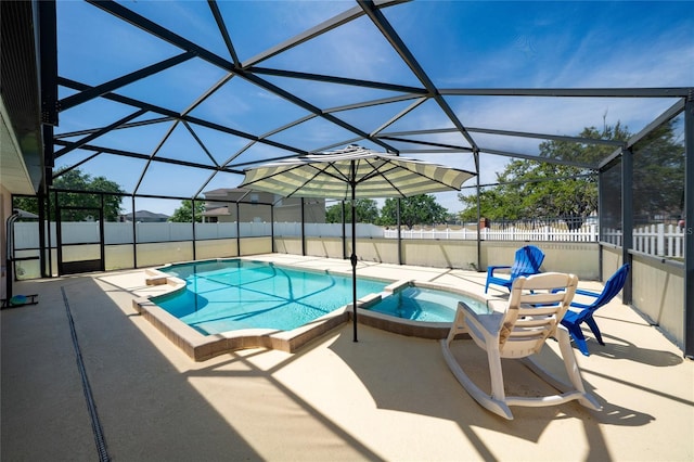 654 Chadbury Way, Kissimmee, FL 34744 - view of swimming pool featuring a fenced backyard, a pool with connected hot tub, glass enclosure, and a patio area