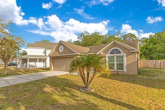 1002 Kelsey Ave, Oviedo, FL 32765 - view of front facade featuring driveway, a front yard, stucco siding, fence, and a garage